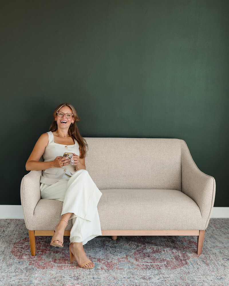 Alex seated, smiling